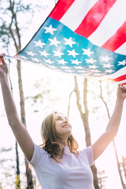 Free Photo happy young female waving flag of usa