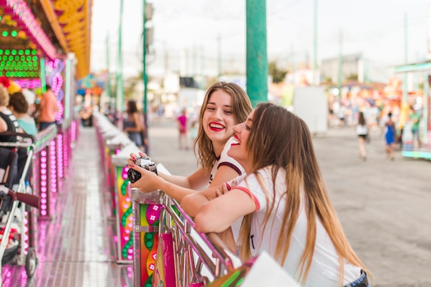 Happy young friends in the amusement park