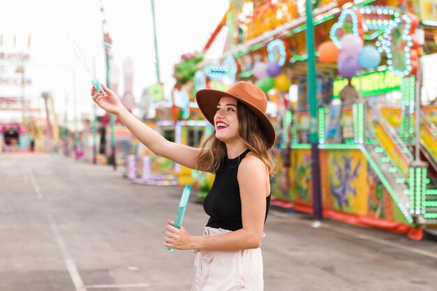 Happy young girl in the amusement park