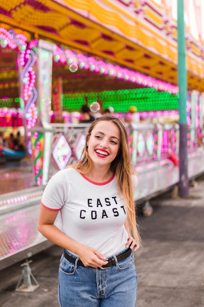 Happy young girl in the amusement park