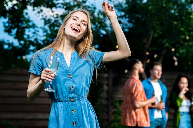 Free Photo happy young girl holding champagne glass