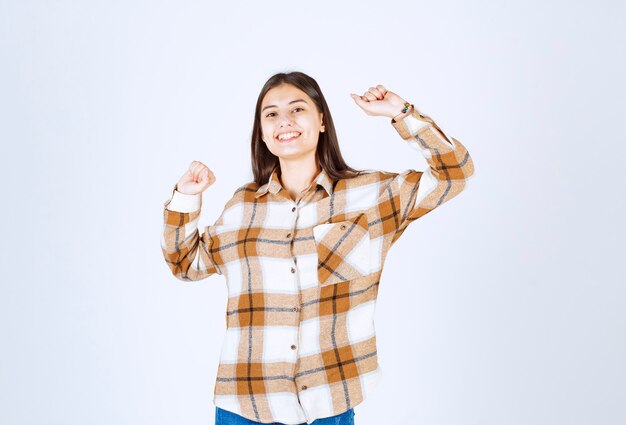 happy young girl with posing with raising hands.