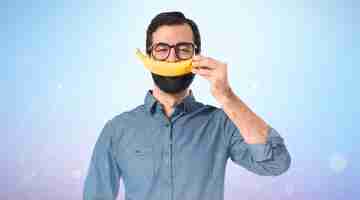 Free photo happy young hipster man with banana