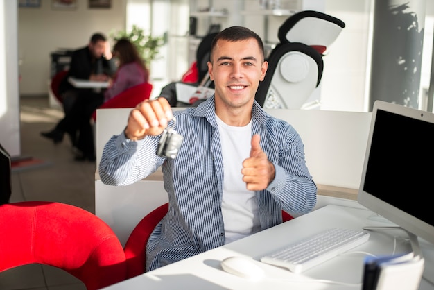 Happy young man holding car keys