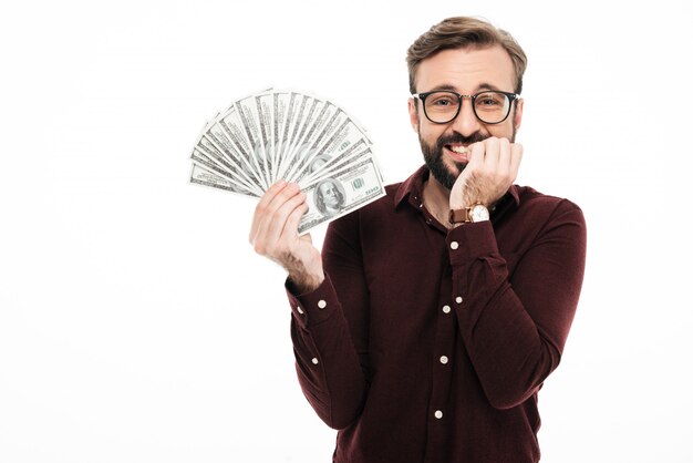 Happy young man holding money.