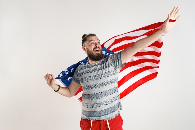 Free photo happy young man with flag of the united states of america isolated on white studio.