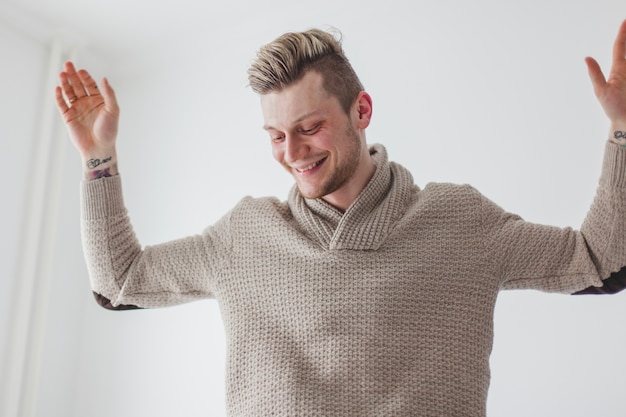 Free Photo happy young man with raised arms