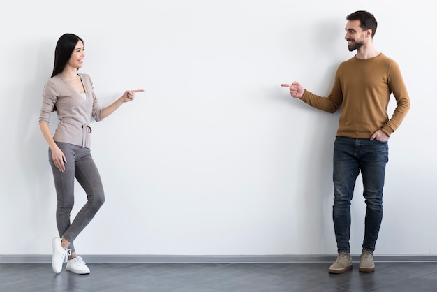 Free photo happy young man and woman posing together