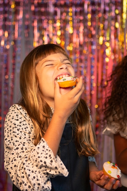 Free Photo happy young pretty girl at festive party eating cupcake