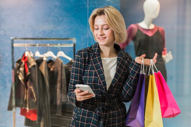 Happy young woman checking her phone