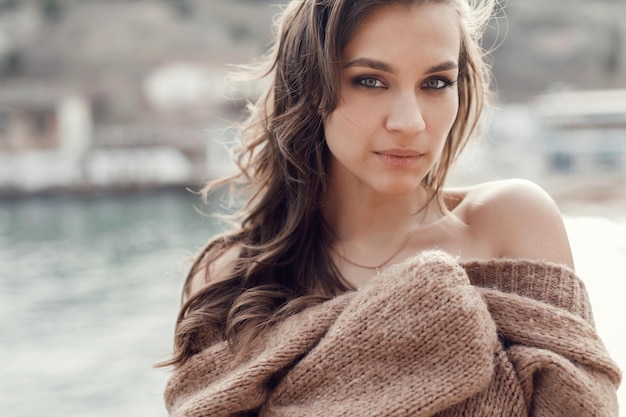 Free photo happy young woman in cozy wear outdoors