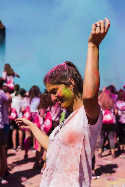 Free photo happy young woman dancing in the holi celebration