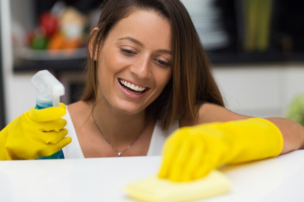 Happy young woman enjoying cleaning