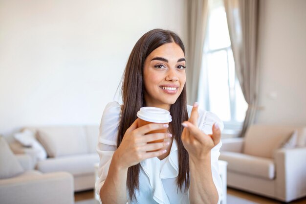 Happy young woman in headphones speaking looking at laptop making notes girl student talking by video conference call female teacher trainer tutoring by webcam online training ecoaching concept