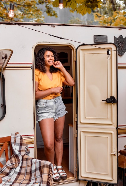 Happy young woman leaning on a door