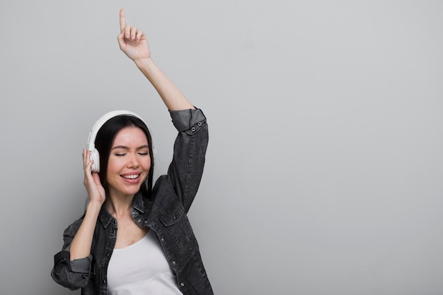 Happy young woman listening to music