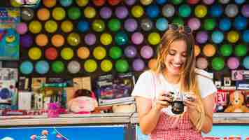 Free photo happy young woman looking in camera at amusement park