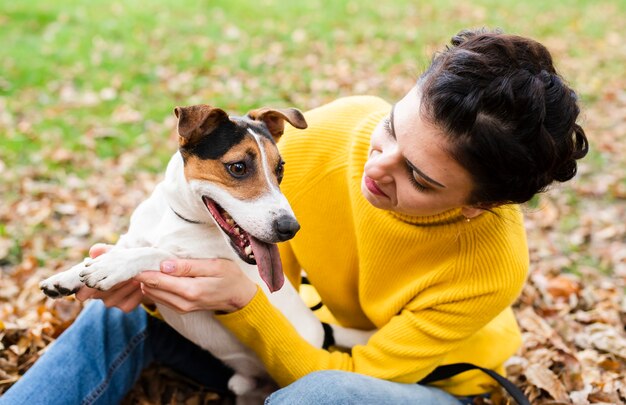 Happy young woman playing with her dog