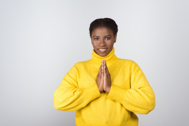 Happy young woman praying and looking