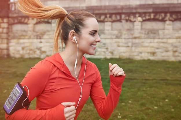 Free Photo happy young woman running outdoors. she's preparing for the marathon