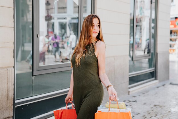 Happy young woman shopping in the city