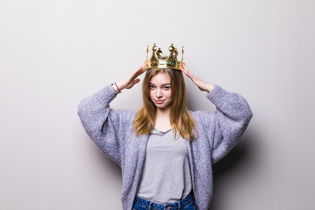 Free photo happy young woman or teen girl in princess crown isolated on gray