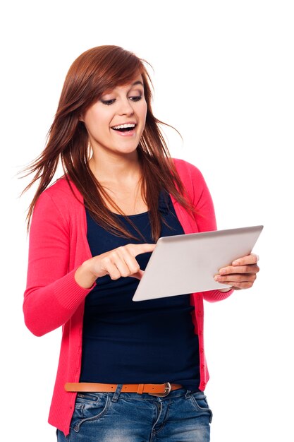 Happy young woman using digital tablet