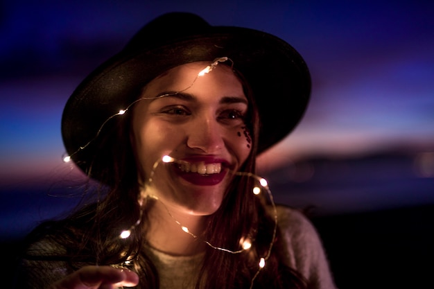 Free Photo happy young woman with burning garland on head