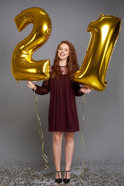 Free Photo happy young woman with golden balloons celebrating her birthday