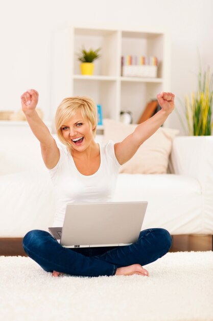 Happy young woman with hands raised