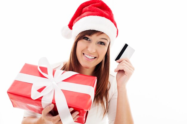 Happy young woman with red gift box and credit card