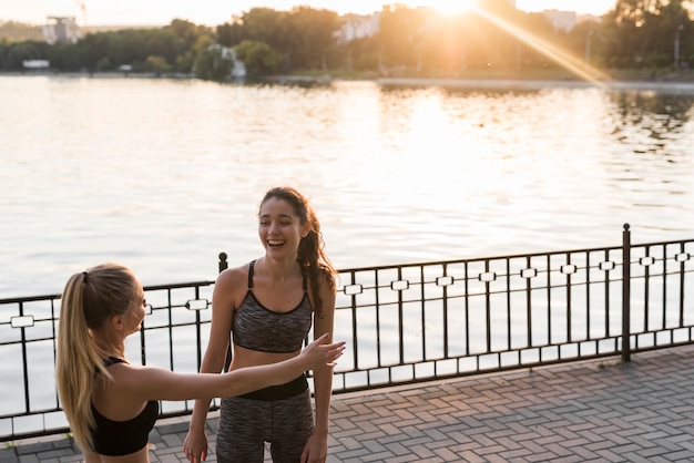 Free photo happy young women after training in the park