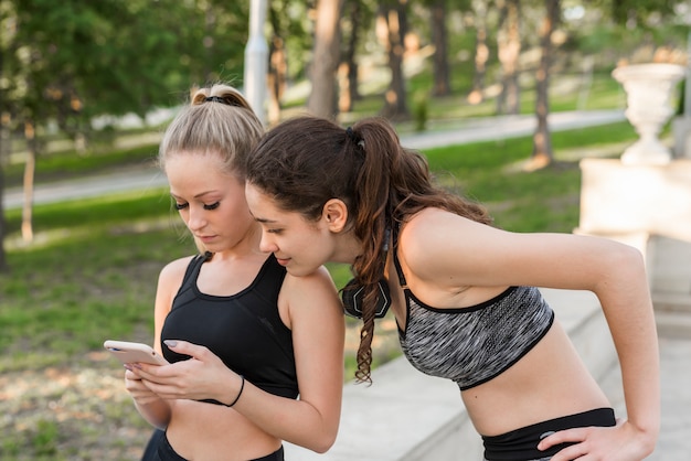 Free photo happy young women after training in the park