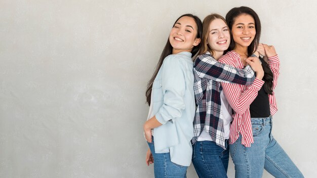 Happy young women posing in studio