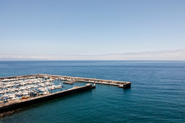 Free photo harbor with boats and blue sea