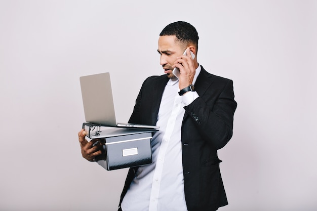 Free photo hard-working astonished businessman with office box, folders, laptop talking on phone. office worker, career, smart manager, misunderstanding, leadership.