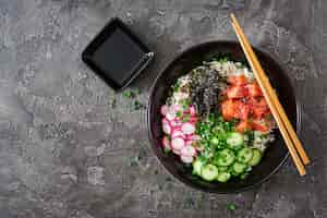 Free photo hawaiian salmon fish poke bowl with rice. top view. flat lay