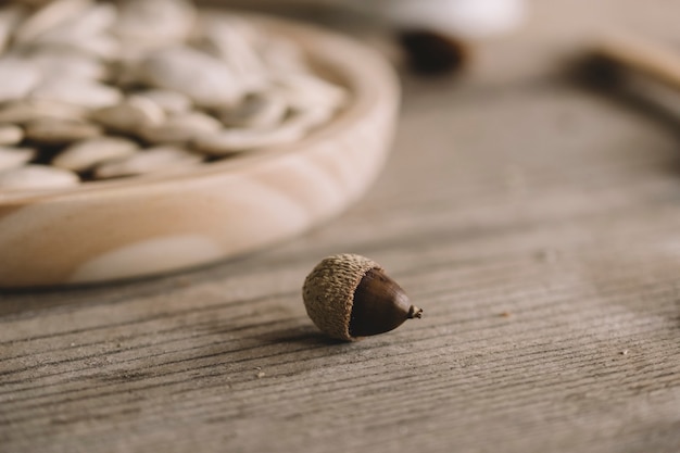 Free photo hazelnut next to wooden plate