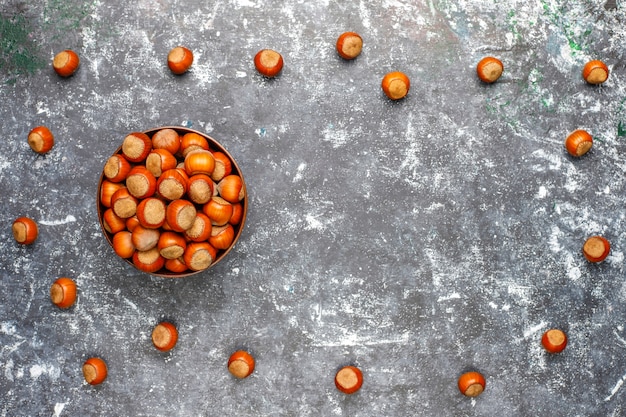 Hazelnuts on concrete background, top view