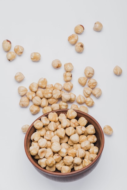 Free photo hazelnuts spilled near bowl