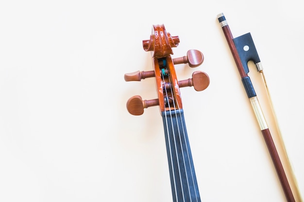 Head of classical violin with bow on white background