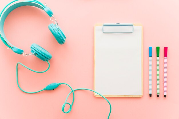 Headphones, clipboard and pencils