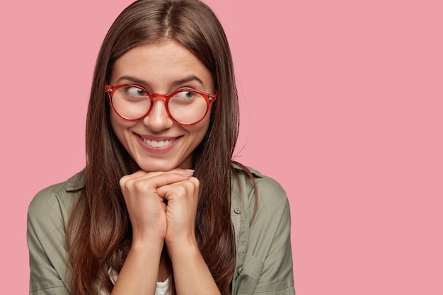 Free photo headshot of dreamy pleased woman with tender smile