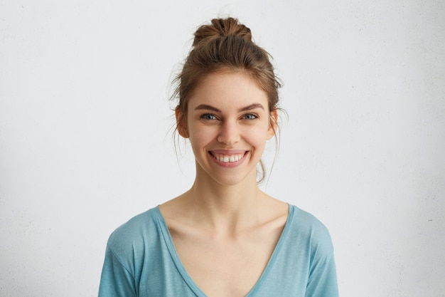 Free Photo headshot of pleasant-looking young caucasian woman with broad smile showing her straight white teeth being happy