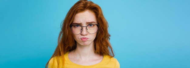 Free Photo headshot portrait of tender redhead teenage girl with serious expression looking at camera caucasian