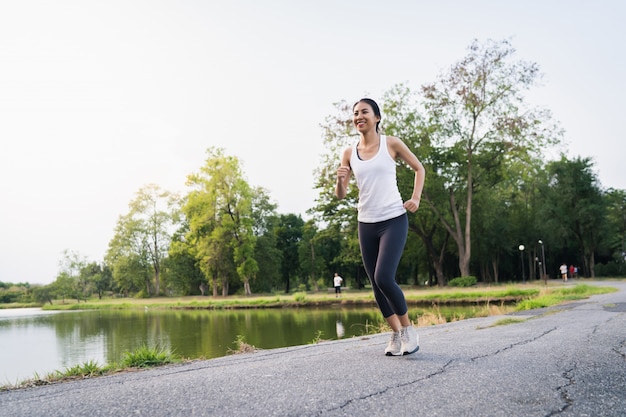 Healthy beautiful young Asian runner woman in sports clothing running and jogging 