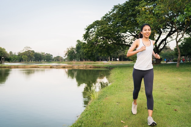 Healthy beautiful young Asian runner woman in sports clothing running and jogging