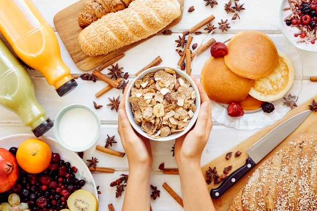 Healthy breakfast concept with hands holding cereals