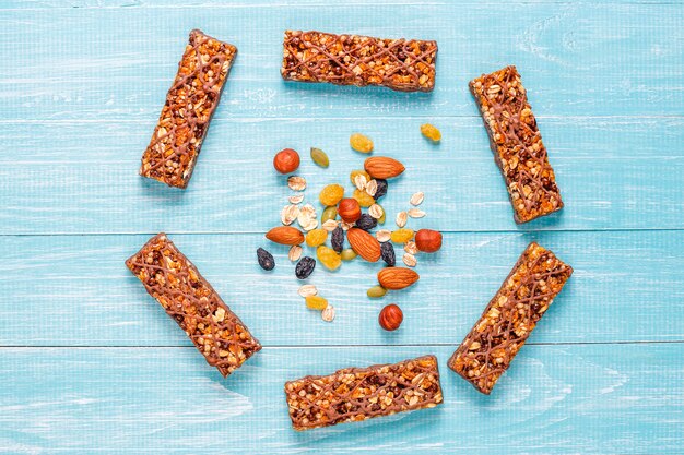 Healthy delicios granola bars with chocolate, muesli bars with nuts and dry fruits, top view