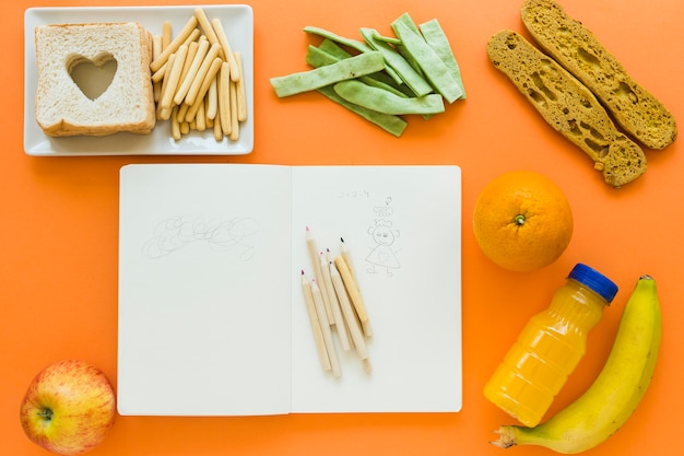 Free photo healthy food around notebook with doodles